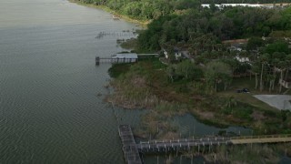 AX0035_130 - 5K aerial stock footage fly over docks by homes on the shore of Lake Apopka, Ocoee, Florida