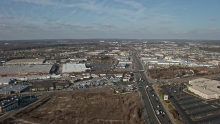 AX0065_0002 - 5K aerial stock footage follow Broadhollow Road to approach stores and shopping centers in Farmingdale, Long Island, New York, winter