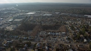 AX0065_0013E - 5K aerial stock footage of suburban residential neighborhood and big box stores in Syosset, Long Island, New York, winter