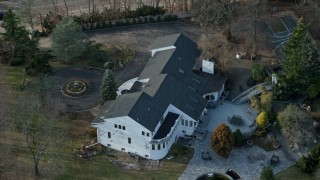 AX0065_0015N - 5K aerial stock footage of an upscale home in Syosset, Long Island, New York, winter