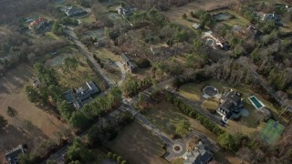 AX0065_0016 - 5K aerial stock footage of a bird's eye view of large, upscale homes in Syosset, Long Island, New York, winter