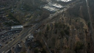 AX0065_0023 - 5K aerial stock footage of passing Northern Boulevard between car dealerships and Roslyn Cemetery in Greenvale, Long Island, New York, winter