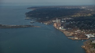 AX0065_0024E - 5K aerial stock footage of Hempstead Harbor and a power plant with smoke stacks on the shore in Glenwood Landing, Long Island, New York, winter