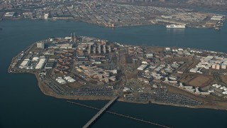 AX0065_0039 - 5K stock footage aerial video of flying by Rikers Island prison in New York City, winter