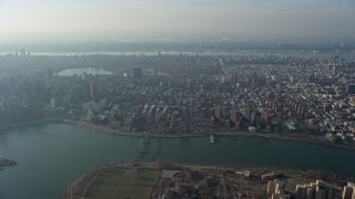 AX0065_0042 - 5K aerial stock footage approach public housing, urban neighborhoods, and Central Park, Upper East Side, Harlem, New York City, winter