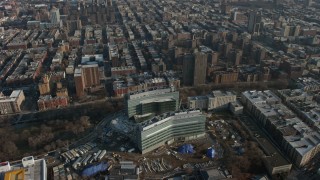 AX0065_0051E - 5K aerial stock footage of urban neighborhoods in Harlem and office buildings in Manhattanville, New York City, winter