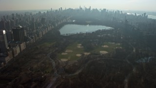 AX0065_0054 - 5K aerial stock footage fly over Central Park to approach baseball fields and the reservoir, New York City, winter