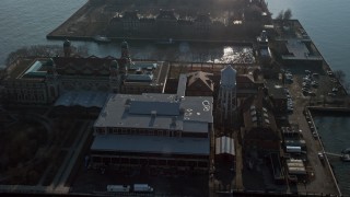 AX0065_0075 - 5K aerial stock footage approach and fly over the Immigrant Building on Ellis Island, New York, winter
