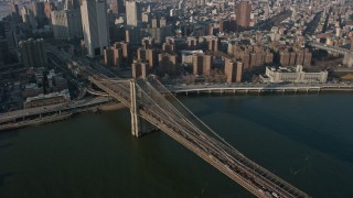 AX0065_0104 - 5K aerial stock footage tilt to heavy traffic crossing the Brooklyn Bridge, New York City, winter