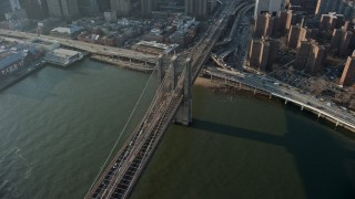 AX0065_0105 - 5K aerial stock footage of heavy traffic leaving Lower Manhattan on the Brooklyn Bridge, New York City, winter