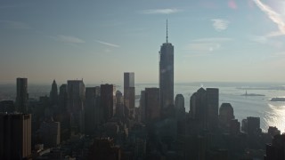 AX0065_0110 - 5K aerial stock footage of a view of One World Trade Center towering over Lower Manhattan skyscrapers, New York City, winter