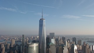 AX0065_0135E - 5K aerial stock footage approach and flyby One World Trade Center and Lower Manhattan skyscrapers from the Hudson River, New York City, winter