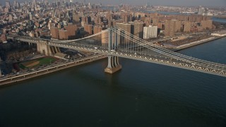 AX0065_0154 - 5K aerial stock footage of light traffic crossing the Manhattan Bridge, New York City, winter