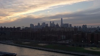 AX0065_0171 - 5K aerial stock footage of Lower Manhattan skyline seen from public housing by the East River on the Lower East Side, New York City, winter, sunset