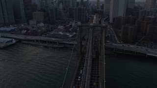 AX0065_0179 - 5K aerial stock footage of tracking the Brooklyn Bridge with heavy traffic, New York City, winter, twilight