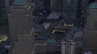 AX0065_0211 - 5K aerial stock footage flyby the World Trade Center Memorial in Lower Manhattan, New York City, winter, twilight