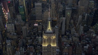 AX0065_0235E - 5K aerial stock footage approach the Empire State Building in Midtown Manhattan, New York City, winter, twilight