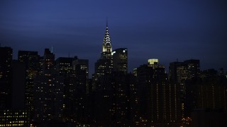 AX0065_0272 - 5K aerial stock footage of the Chrysler Building and surrounding skyscrapers, Midtown Manhattan, New York City, winter, night