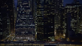 AX0065_0283 - 5K aerial stock footage flyby FDR Drive and tall skyscrapers in Lower Manhattan, New York City, winter, night