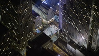 AX0065_0332E - 5K stock footage aerial video orbit Rockefeller Center to reveal the ice skating rink, Midtown Manhattan, New York City, winter, night