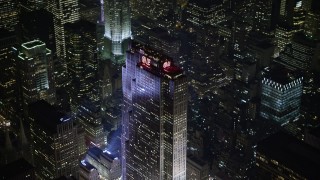AX0065_0339 - 5K aerial stock footage of flying away from Rockefeller Center in Midtown Manhattan, New York City, winter, night