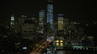 AX0065_0373E - 5K aerial stock footage approach West Street and piers in Greenwich Village, skyscrapers in Lower Manhattan, New York City, winter, night