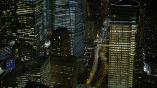 AX0065_0377E - 5K aerial stock footage flyby World Trade Center skyscrapers to reveal the World Trade Center Memorial in Lower Manhattan, New York City, winter, night