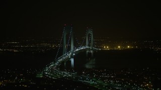 AX0065_0399E - 5K aerial stock footage of passing by the Verrazano-Narrows Bridge in New York City, winter, night