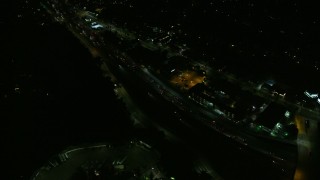AX0156_006 - 7.6K aerial stock footage of heavy traffic on Highway 101 through Studio City at night in California