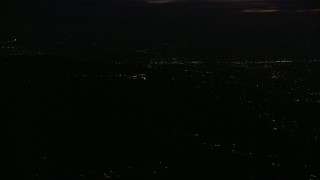 AX0156_007 - 7.6K aerial stock footage of a view of the Griffith Observatory in the hills at night in Los Angeles, California