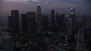 AX0156_054 - 7.6K stock footage aerial video of a view of towering skyscrapers in Downtown Los Angeles at sunrise, California