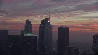 AX0156_056E - 7.6K aerial stock footage of the top of Wilshire Grand Center in Downtown Los Angeles at sunrise, California