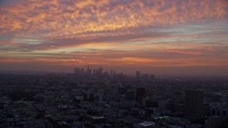 AX0156_071E - 7.6K aerial stock footage of golden clouds above Downtown Los Angeles, California early in the morning