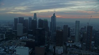 AX0156_085E - 7.6K aerial stock footage approaching Downtown Los Angeles, California skyline and Wilshire Grand Center tower on a hazy morning