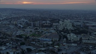 AX0156_090 - 7.6K aerial stock footage of the University of Southern California Health Sciences Campus in Boyle Heights, Los Angeles, California at sunrise