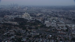 AX0156_099 - 7.6K stock footage aerial video flying by University of Southern California Health Sciences Campus in Boyle Heights, Los Angeles, California at sunrise