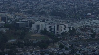 AX0156_100 - 7.6K aerial stock footage of Keck Hospital at the Health Sciences Campus in Boyle Heights, Los Angeles, California at sunrise