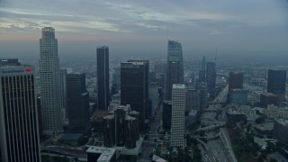 AX0156_105E - 7.6K aerial stock footage of US Bank Tower and skyscrapers in Downtown Los Angeles, California at sunrise