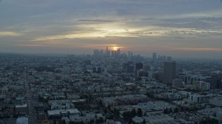 AX0156_109 - 7.6K aerial stock footage approaching Koreatown office buildings and the skyline of Downtown Los Angeles, California at sunrise