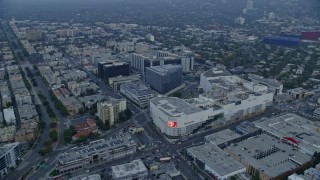 AX0156_122E - 7.6K aerial stock footage orbit of Beverly Center and Cedars-Sinai Medical Center at sunrise, Beverly Hills, California
