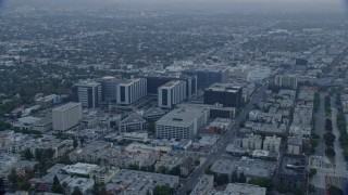 AX0156_125E - 7.6K aerial stock footage orbiting Cedars-Sinai Medical Center at sunrise in Beverly Hills, California