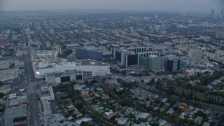 AX0156_127E - 7.6K aerial stock footage orbiting Beverly center and Cedars-Sinai Hospital, sunrise, Beverly Hills, California