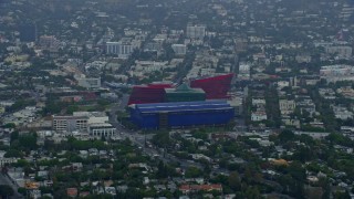 AX0156_129 - 7.6K aerial stock footage of a side view of the MOCA Pacific Design Center, sunrise, Beverly Hills, California