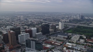 AX0156_140 - 7.6K stock footage aerial video flying over apartment buildings following Wilshire Boulevard towards Interstate 405, sunrise, Westwood Village, California
