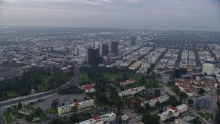 AX0156_141 - 7.6K stock footage aerial video flying over Interstate 405 and apartment buildings following Wilshire Boulevard, sunrise, Sawtelle, California