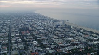 AX0156_147E - 7.6K aerial stock footage flying over residential areas and office buildings near Santa Monica Pier, sunrise, Santa Monica, California