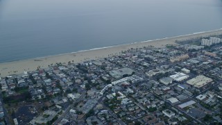 AX0156_154 - 7.6K aerial stock footage passing homes by the beach at sunrise, Venice, California