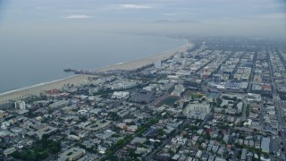 AX0156_155E - 7.6K aerial stock footage flying over Santa Monica neighborhoods to approach Santa Monica Pier at sunrise, California