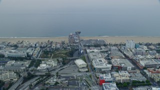 AX0156_157E - 7.6K aerial stock footage of beachfront shops near Santa Monica Pier in the morning, Santa Monica, California