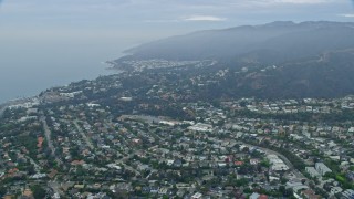 AX0156_161E - 7.6K aerial stock footage flying over Palisades Charter High School and coastal neighborhoods at sunrise, Pacific Palisades, California
